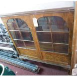 An early 20th century burr walnut display cabinet, with two astral glazed doors, enclosing