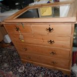 An early 20th century pine chest of drawers, together with a pine mirror