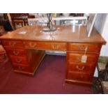 A 1940's oak pedestal desk, with nine drawers, H.76 W.138 D.78cm