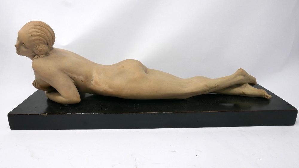 An Italian Art Deco plaster figure of a reclining nude, indistinctly signed and dated '13 to base,