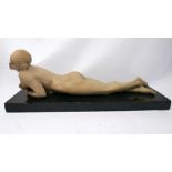 An Italian Art Deco plaster figure of a reclining nude, indistinctly signed and dated '13 to base,