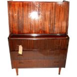 A 1950's Italian mahogany bureau, with a fitted fall front over three long drawers raised on