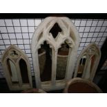 A Gothic style reconstituted stone mirror, H.79 W.37cm, together with a pair of smaller Gothic style