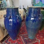 A pair of large Persian Sharab blue glazed wine vessels, having six handles, H.90cm