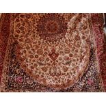 A Kashan style carpet with central floral medallion, on a beige ground, contained by floral