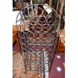 A wrought metal bistro wine rack of arched form, H.130cm W.50cm D.20cm