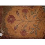 A Persian style rug, decorated with flower to centre on tan ground within floral borders on a maroon