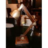 A nautical inspired adjustable wooden desk lamp with brass shade, approx. H.80cm