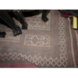 A Persian prayer rug, with geometric design on a brown ground, within geometric borders, fringed,