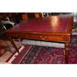 An early 19th Century Regency mahogany library writing table, with gilt tooled red leather top