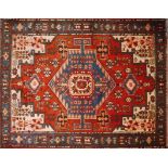 A North West Persian Nahavand rug, central diamond medallion on a terracotta field, within a