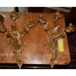 A pair of Rococo style three branch ormolu wall sconces, H.53 W.37cm