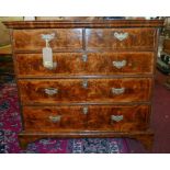 An 18th century veneered figured walnut chest of two short over three long drawers, raised on