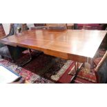 A 20th century Heals dining table, with exotic hardwood top, having fold in butterfly leaf, raised