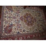 A 20th century Isfahan carpet with central floral medallion on a cream ground, surrounded by