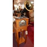 A vintage record player, with built in CD and radio, with brass horn raised on stand, together