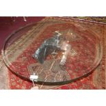 An Artedi coffee table with bevelled glass top raised on marble base, H.40 Diameter.102cm