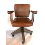 A vintage industrial swivel desk chair, raised on Archibald Kenrick & sons castors