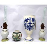 An early 20th century Meissen design ceramic vase, together with two oil lamps in the form of owls