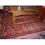 An antique North East Persian Turkoman carpet, repeating stlyised Tekkeh motifs on a terracotta