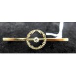 Antique 9ct yellow gold and diamond circular bar brooch, set with a central collet-set diamond and