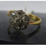 An cased antique 18ct yellow gold and diamond cluster ring in the form of a flower head, set with