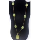 An antique 9ct yellow gold chain necklace set with seven polished green agate beads, 60g, L: 108cm