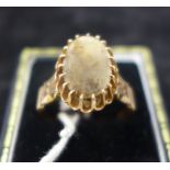 An antique rose gold ladies ring, centrally set with an oval panel of polished agate in a multi-claw