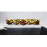 A Victorian 15ct yellow gold bracelet set with three cabochon garnets and two diamonds, 11.5g, 6cm