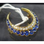 A Victorian 18ct yellow gold sapphire and diamond crescent brooch set with nineteen graduated