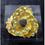 An 18ct yellow gold Italian brooch of textured spiral form, inset with fifteen turquoise