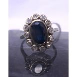 An antique French 18ct white gold sapphire and diamond cluster ring, centrally collet-set with an