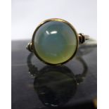 An Arts and Crafts yellow gold ring set with a translucent blue/green chalcedony cabochon, 2.7g,