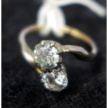An antique yellow gold double diamond crossover ring, inset with two brilliant cut diamonds in