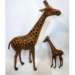 A vintage leather giraffe, H.87cm, together with a vintage leather baby giraffe, H.45cm