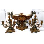 An early 20th century French gilt bronze centre piece, the bowl with twin angel handles held aloft