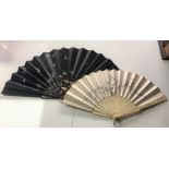 Two antique oriental fans to include a black and hand-painted silk and lacquered frame example L: