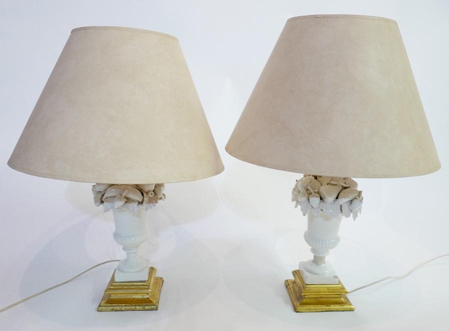 A pair of 20th century white ceramic table lamps in the form of urns of fruit, raised on giltwood - Image 2 of 3