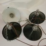 A set of four industrial enamelled ceiling light pendants