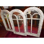 A set of three contemporary arched garden mirrors with distressed wooden frames, H.94cm W.55cm (3)