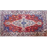 A 20th century North West Persian bakhtiari carpet. Central ivory floral double pendent with