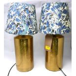 A pair of contemporary hammered copper table lamps