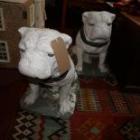 A pair of white painted stone bull dogs