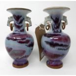 A pair of Chinese flambe vases with everted rim and twin ring handles, bears impressed four