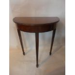 A 20th century inlaid mahogany demi lume console table, raised on tapered legs and spade feet, H.