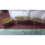 A 20th century mahogany serpentine coffee table with a pair of matching side tables