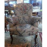 A late 19th century French spoon back armchair, with button back floral upholstery, raised on