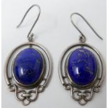 A pair of sterling silver earrings centrally set with an oval lapis lazuli cabochon, 5 x 2.2cm,