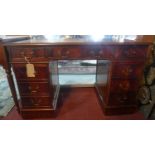 A 20th century mahogany pedestal desk with eight drawers, H.77 W.124 D.61cm