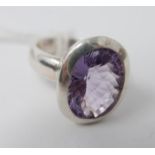 A sterling silver and faceted amethyst ring, centrally set with an oval, faceted amethyst, ring